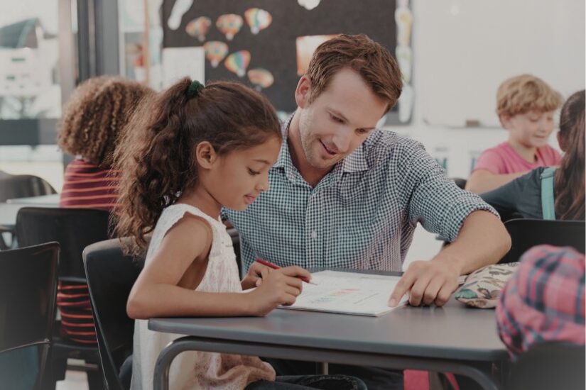 Teacher helping student